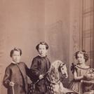 Three children with a rocking horse